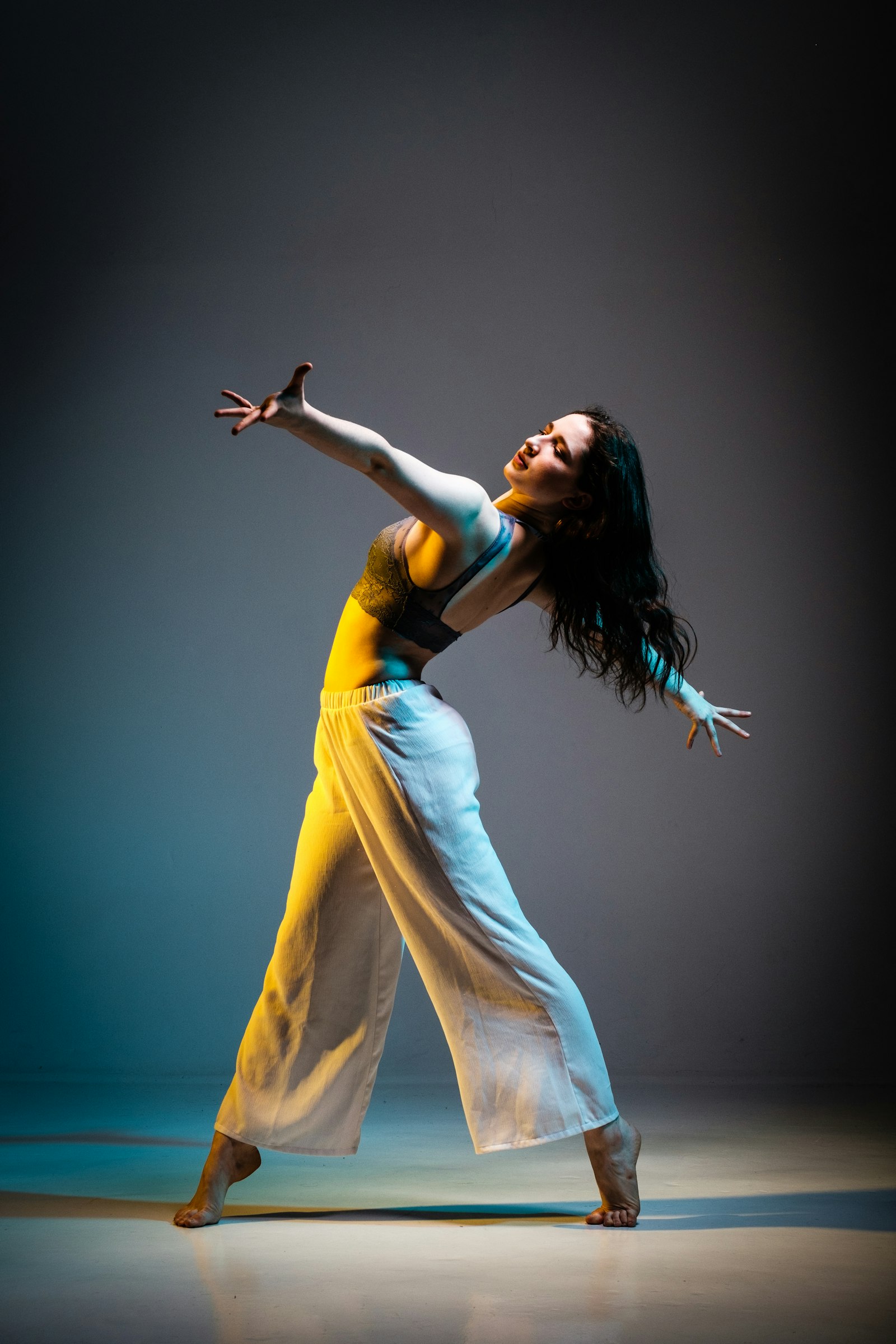 Contemporary dancer under dramatic stage light